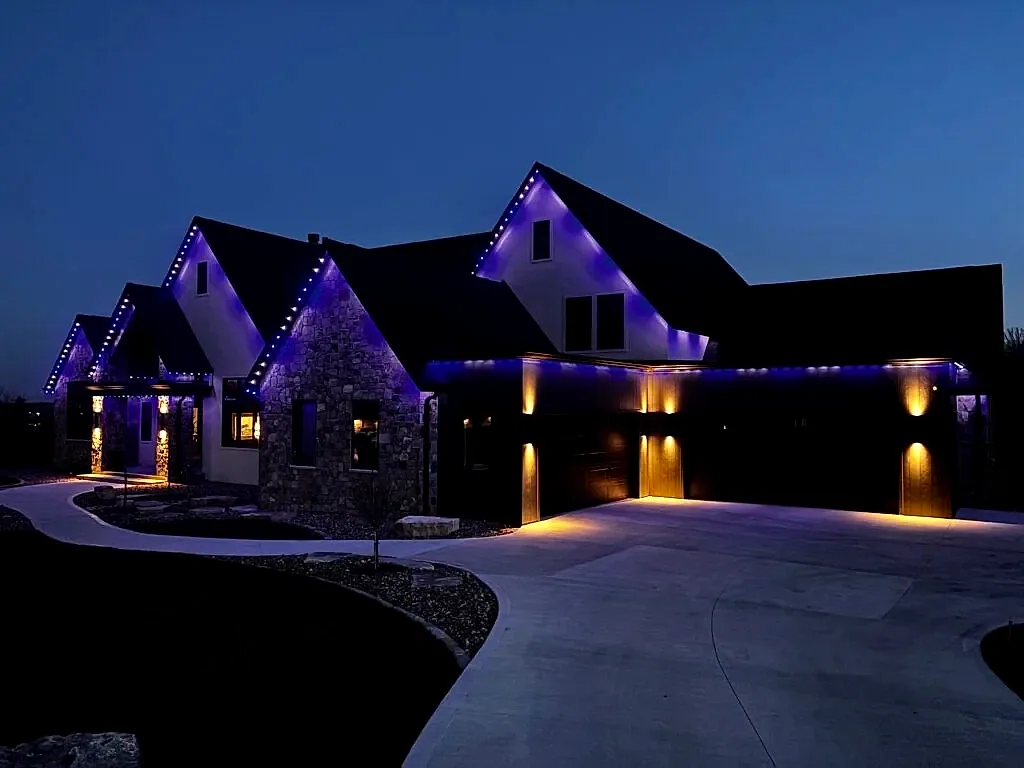 Purple roofline with warm downlights, lit after dark