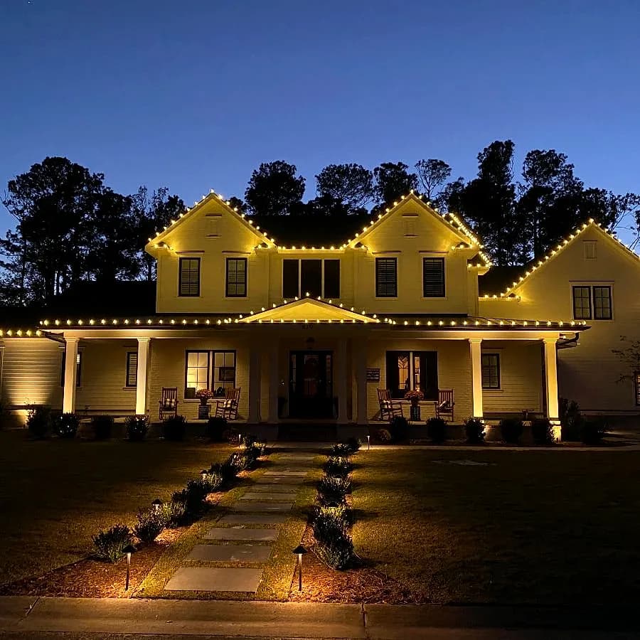 Warm white on a white farmhouse, lit after dark